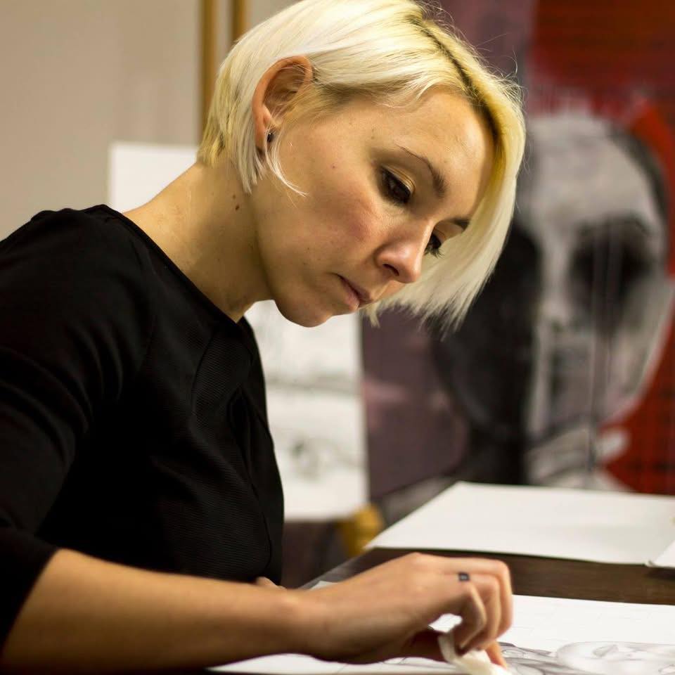 Alexandra Kršňáková working on a painting in her studio